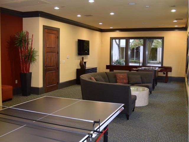 a living room with a ping pong table