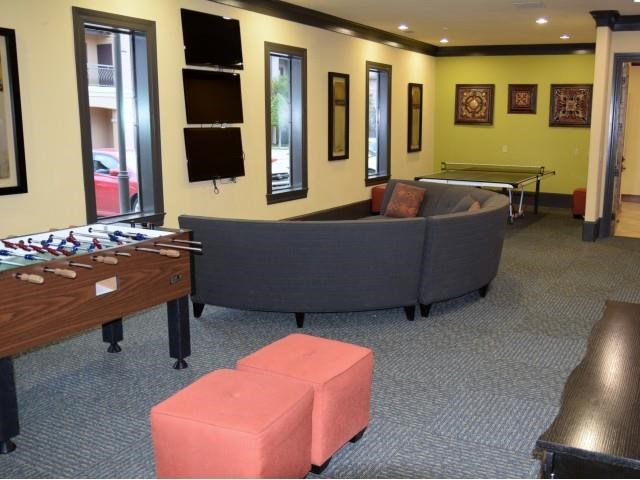 a living room with a couch and a pool table
