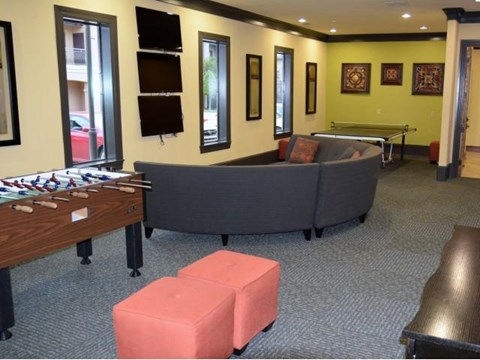 a living room with a couch and a pool table