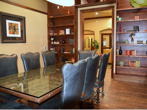 a dining room with a glass table and chairs