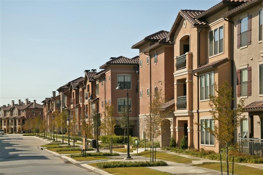 a row of houses on the side of a street
