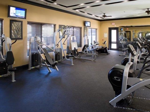 a gym with a lot of exercise equipment in it