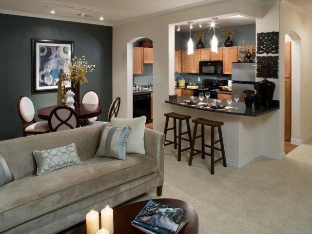 a living room with a kitchen and a couch