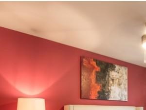 Spacious bedroom large enough to fit a king size bed with luxurious faux wood flooring and modern ceiling fan, beautiful natural light.