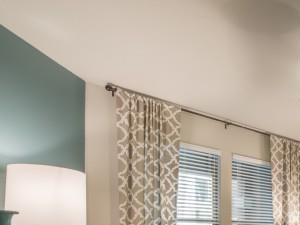 Spacious bedroom large enough to fit a king size bed with luxurious faux wood flooring and modern ceiling fan, beautiful natural light.