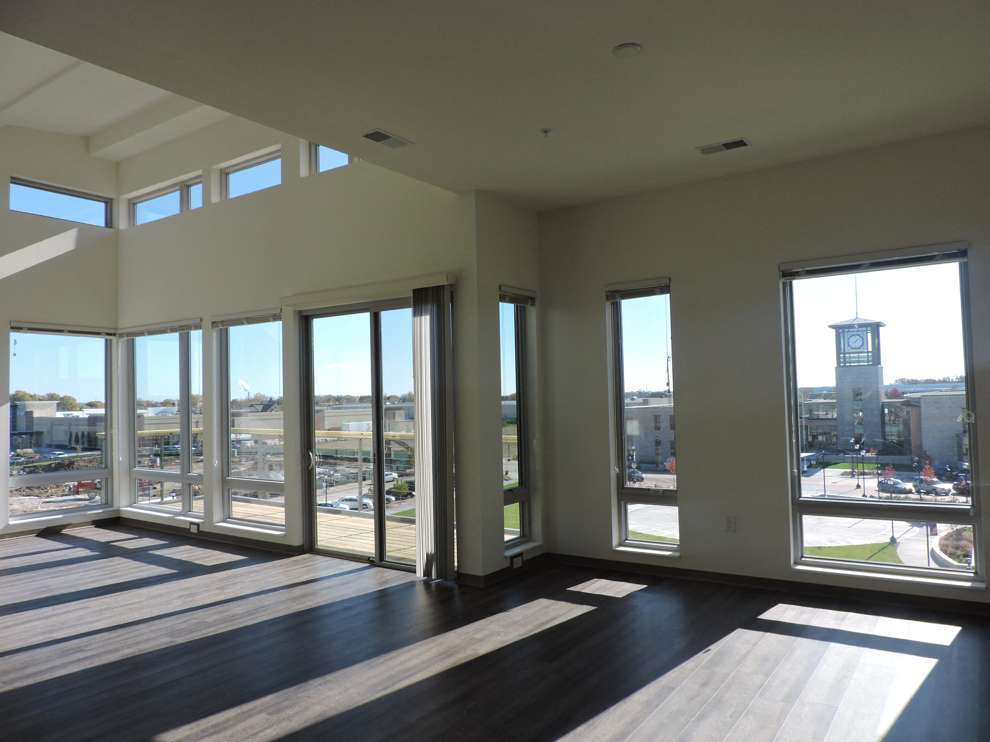 a living room with large windows and a view of a city