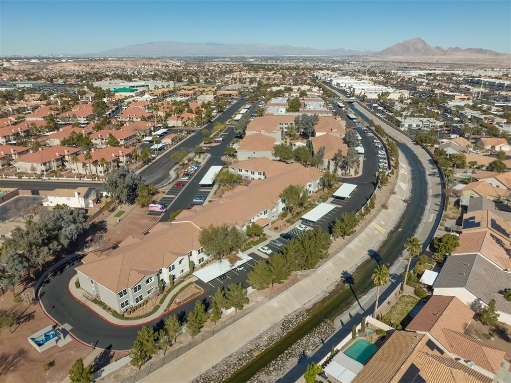 an aerial view of a city with a road and houses
