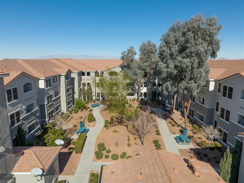 an aerial view of an apartment complex with trees and buildings