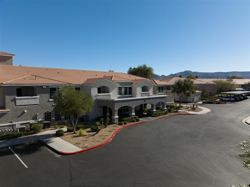 an empty parking lot in front of an apartment building