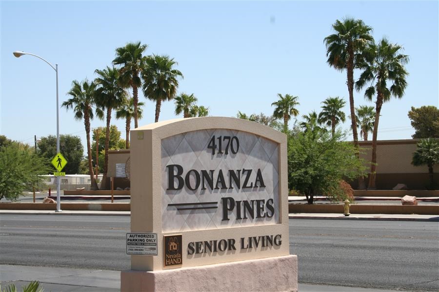 a stone sign sitting on the side of a street