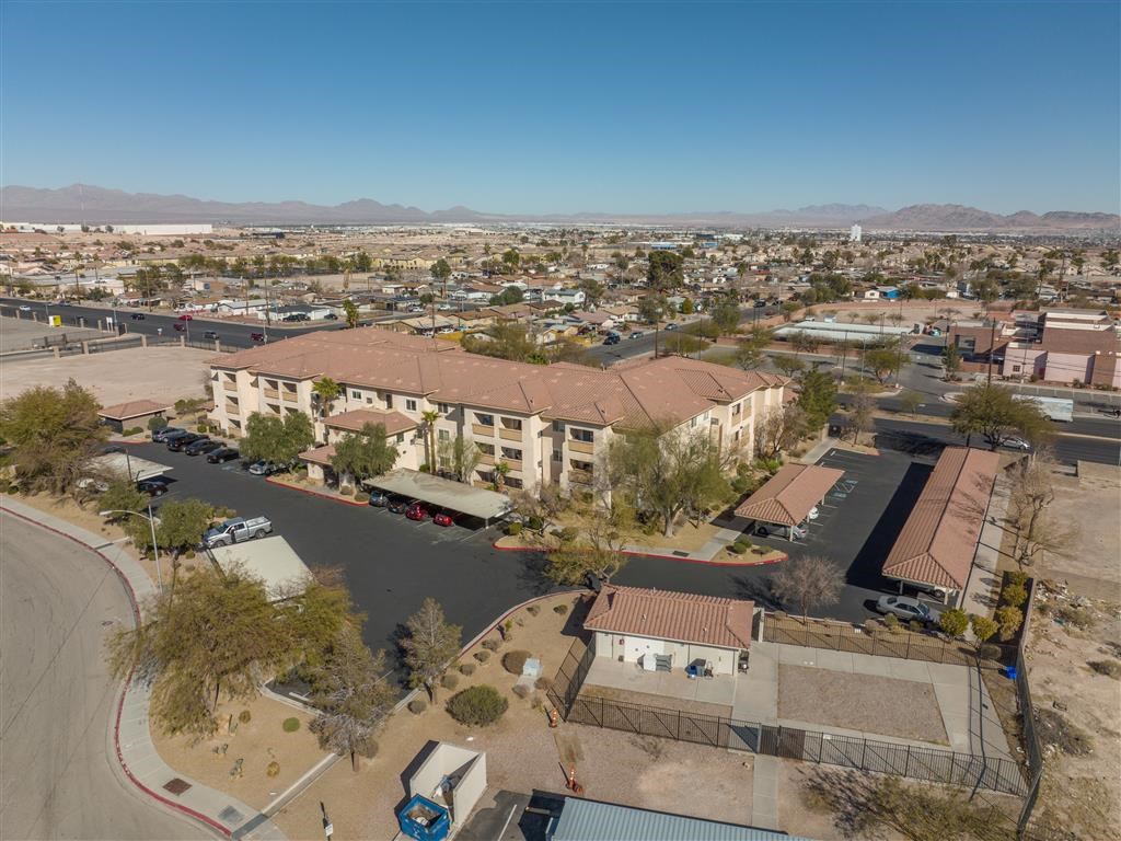 an aerial view of a city with buildings and a parking lot