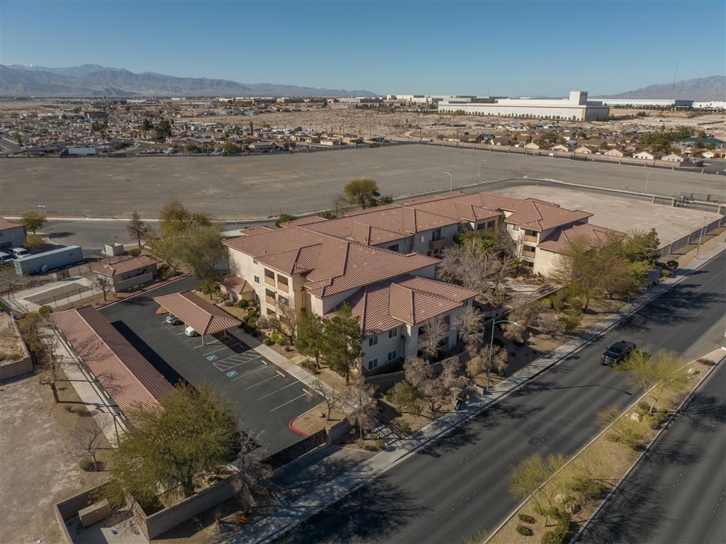 an aerial view of a house and an empty parking lot