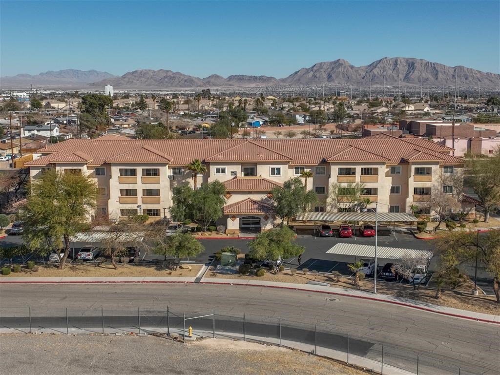 an aerial view of a city with mountains in the background