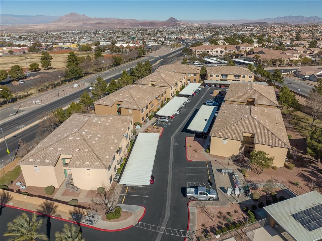 an aerial view of a parking lot and buildings in the desert