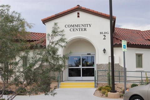 the building of the community center with a car parked outside
