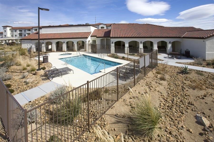 a pool and a house with a fence