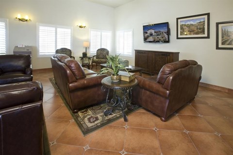 a living room with leather chairs and a table
