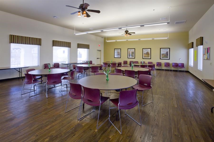 a large dining room with tables and chairs