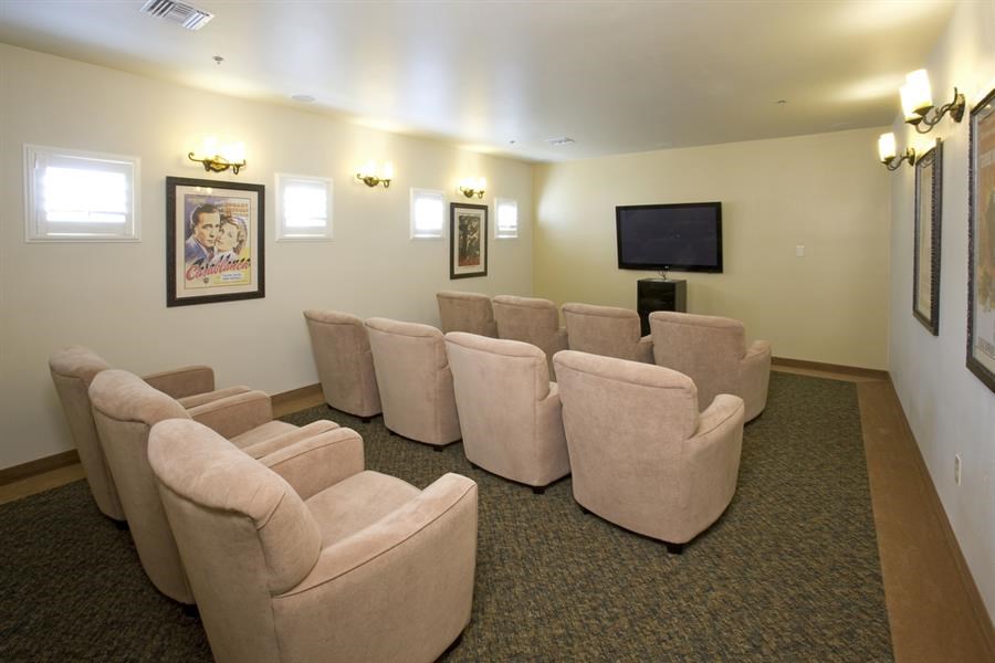 a living room with chairs and a television