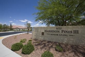 a sign for harrington pines iii senior living on the side of a road