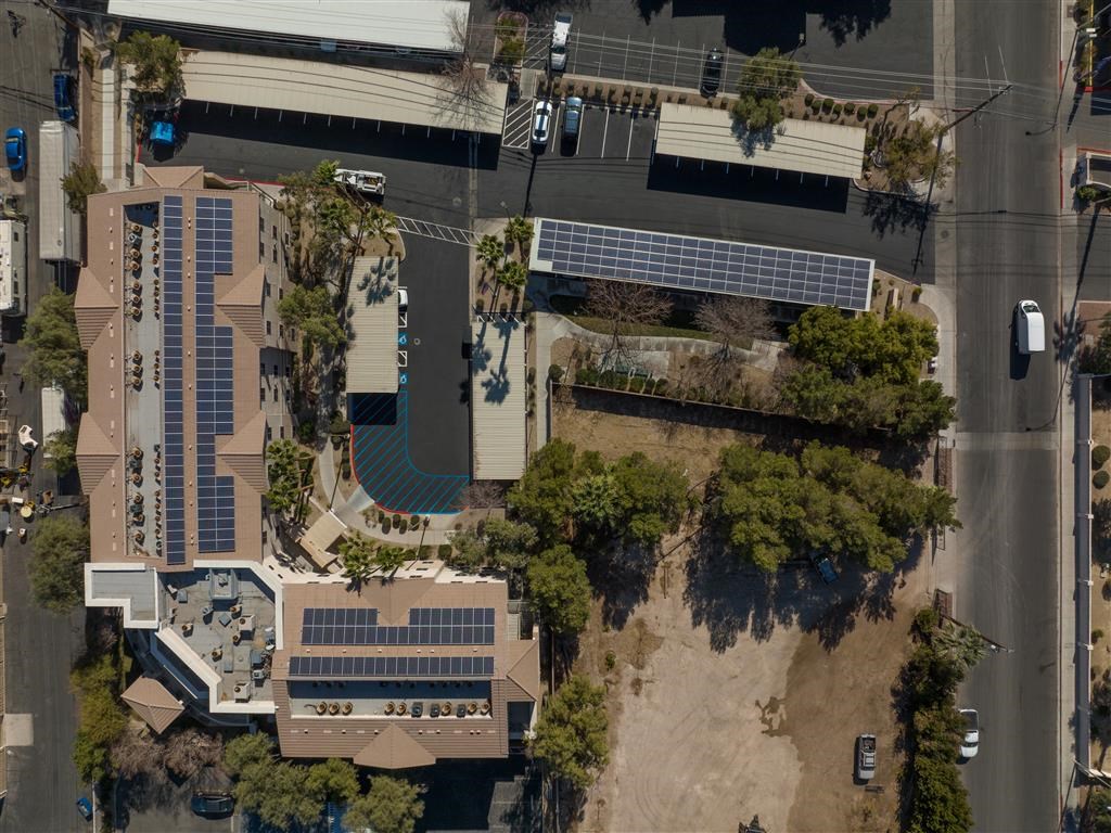 an aerial view of a building with solar panels on the roof