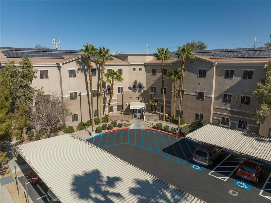 an aerial view of an apartment complex with a swimming pool
