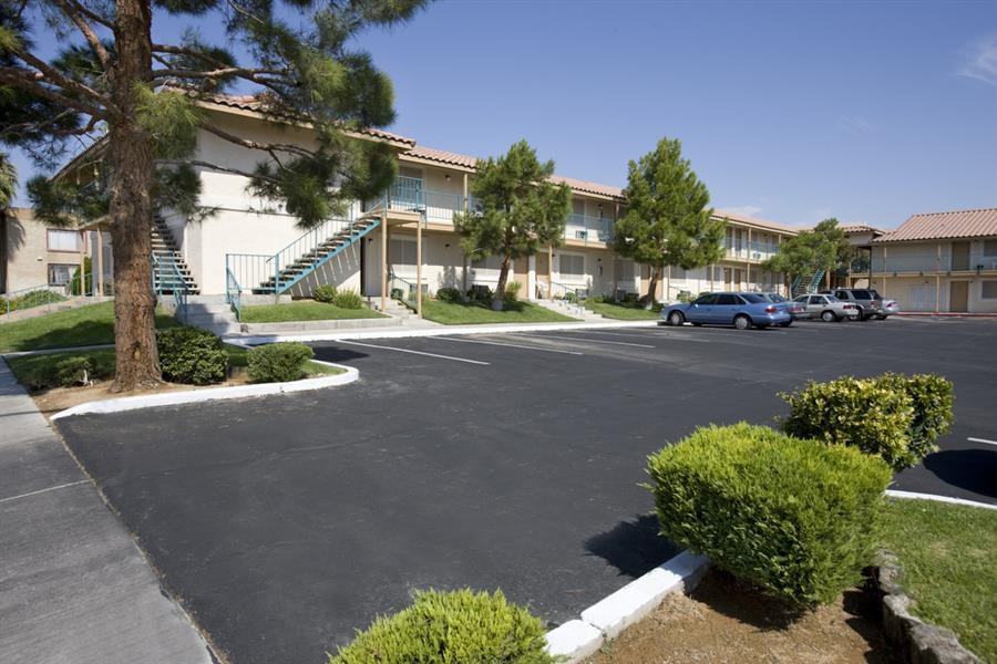 a parking lot in front of an apartment building