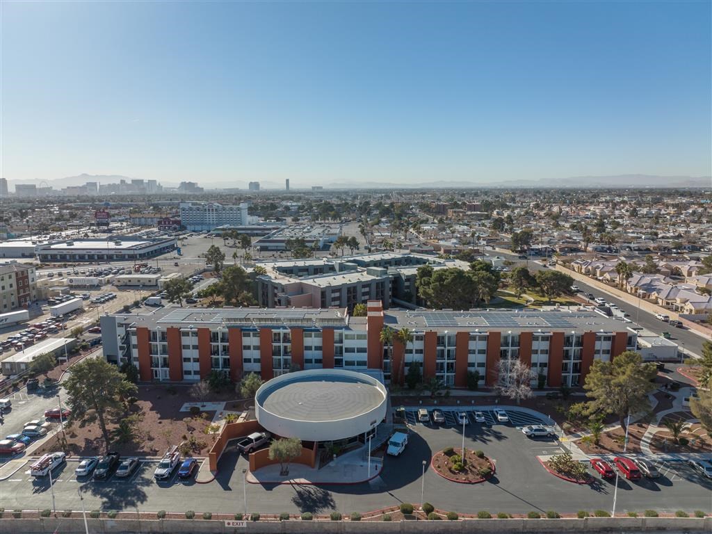 a view of a city from above with a building and parking lot