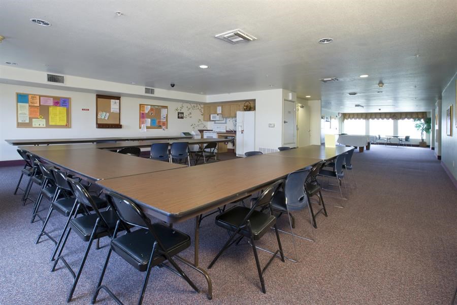 a large meeting room with a long table and chairs