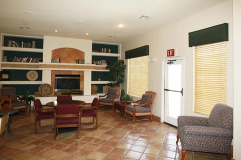 a living room with a table and chairs and a fireplace