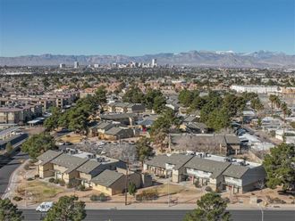 an aerial view of a neighborhood with a city and mountains