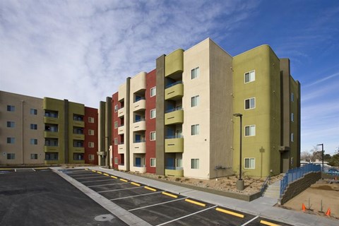 a parking lot in front of an apartment building