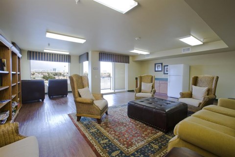 a living room with a couch and chairs and a rug