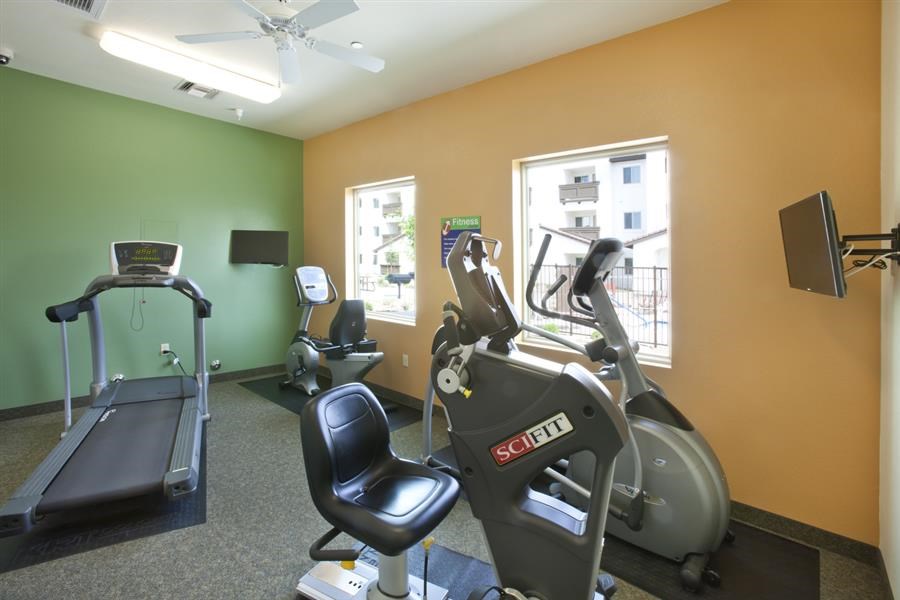 a gym with exercise equipment and a window