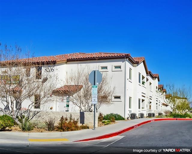 a white building with a stop sign in front of it