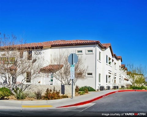 a white building with a stop sign in front of it