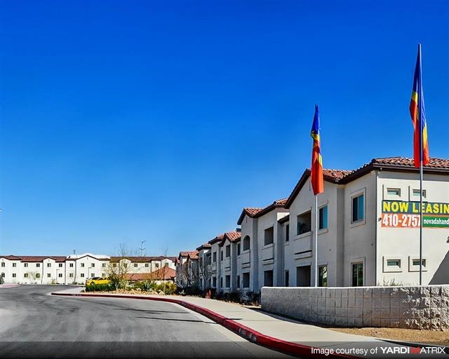a row of buildings with flags and a street