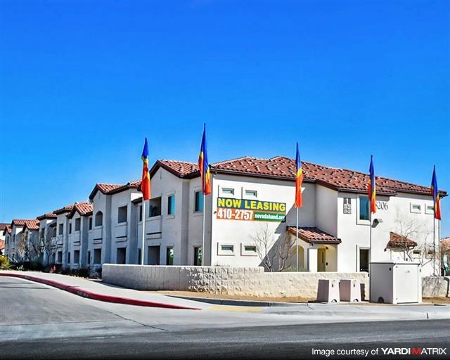 a building with flags and a sign in front of it