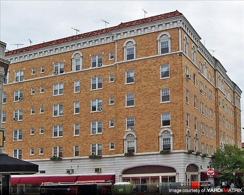 A large red brick building with many windows.
