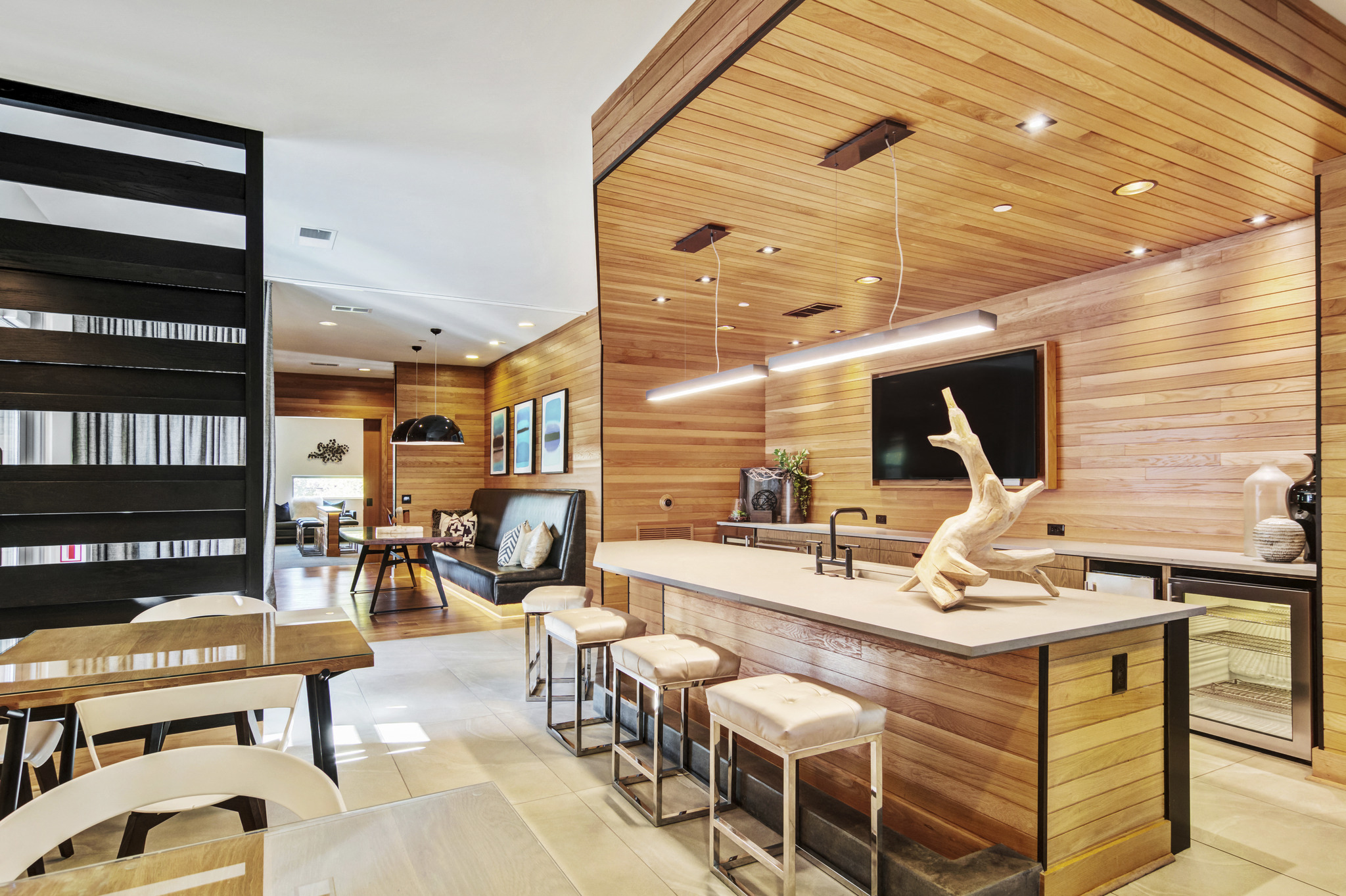 a kitchen with wooden walls and a counter with a statue of a lizard