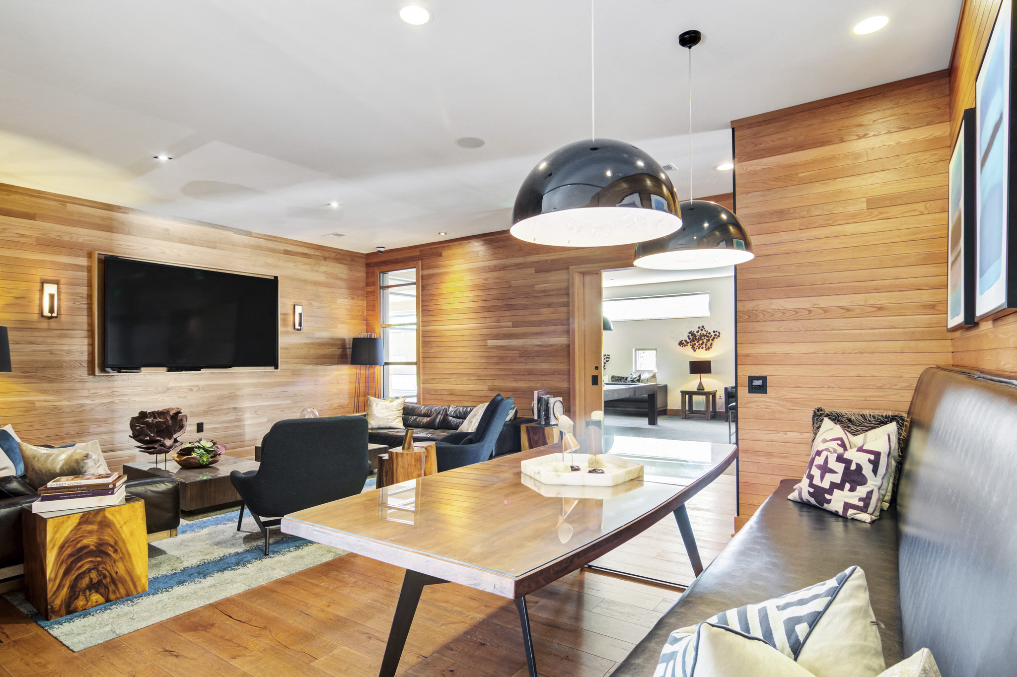 a living room with a table and chairs and a television