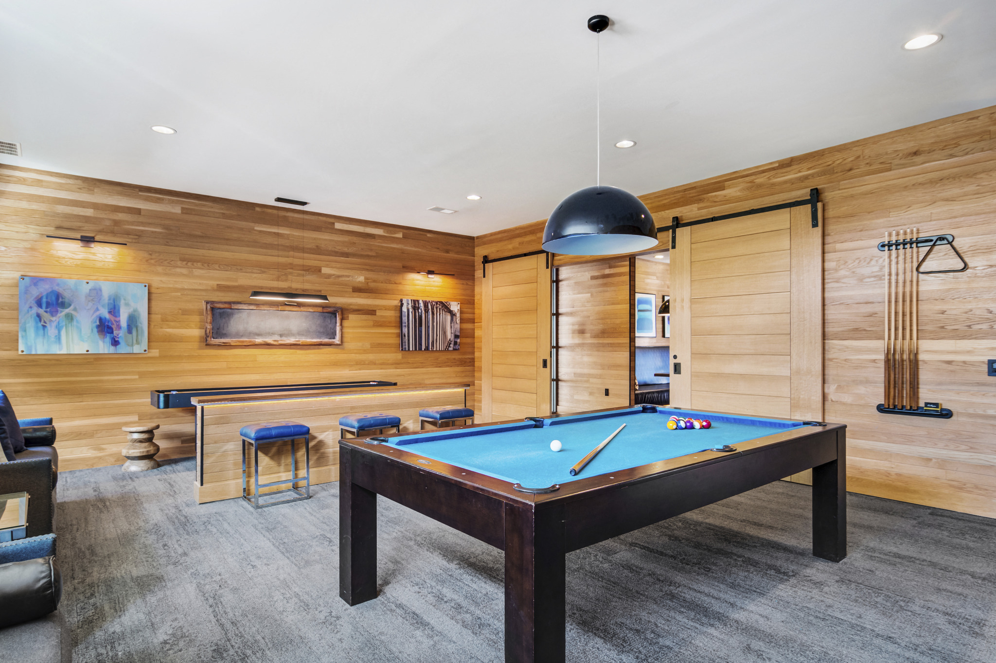 a game room with a pool table and a bar