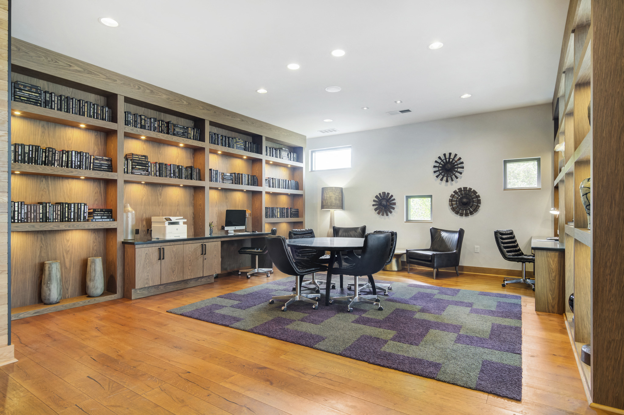 a library with a table and chairs in the center