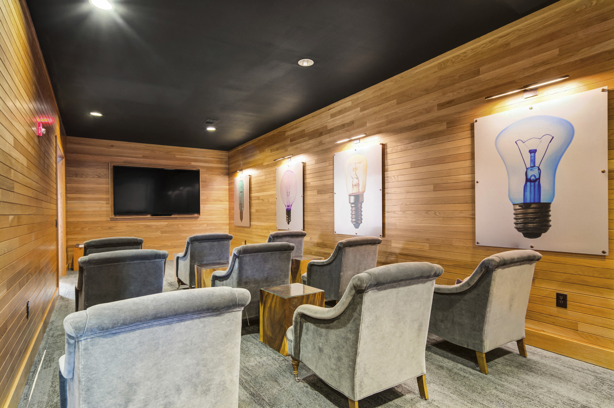 a waiting room with chairs and a tv on the wall