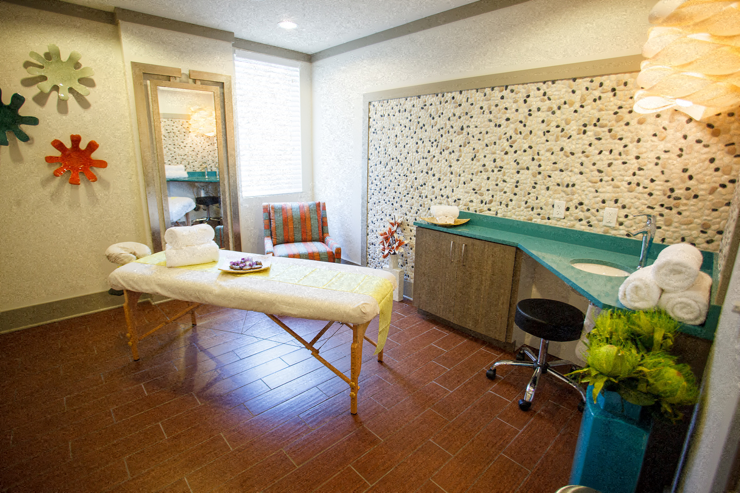 a patient room with a massage table and a sink