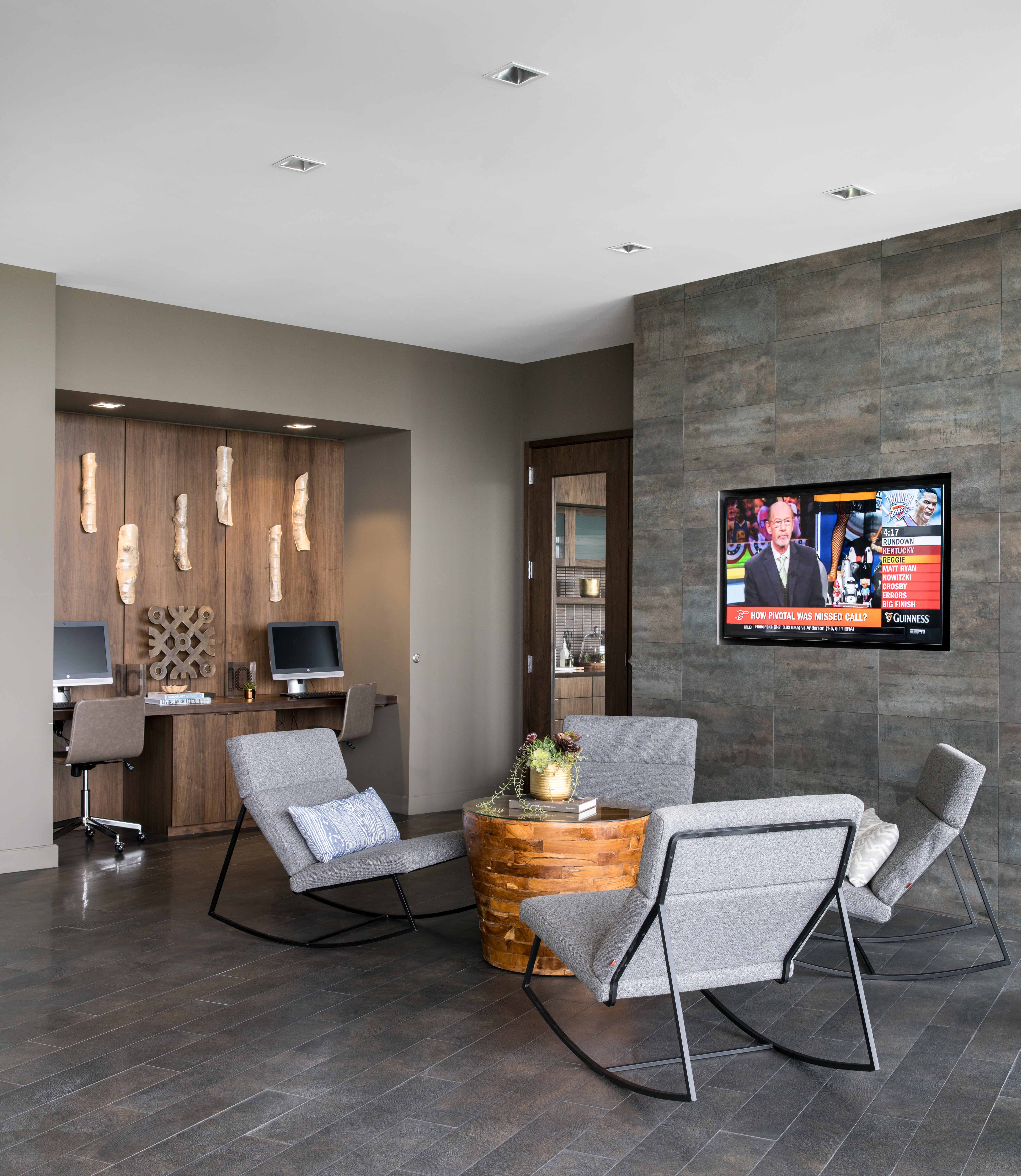 a conference room with two chairs and a tv on the wall