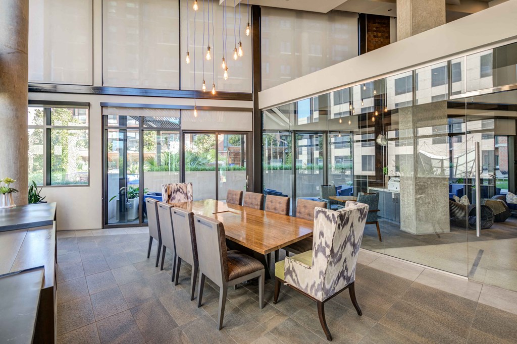 a dining room with a wooden table and chairs