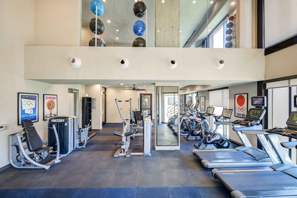 a gym with treadmills and other exercise equipment