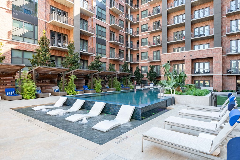 a swimming pool in front of an apartment building