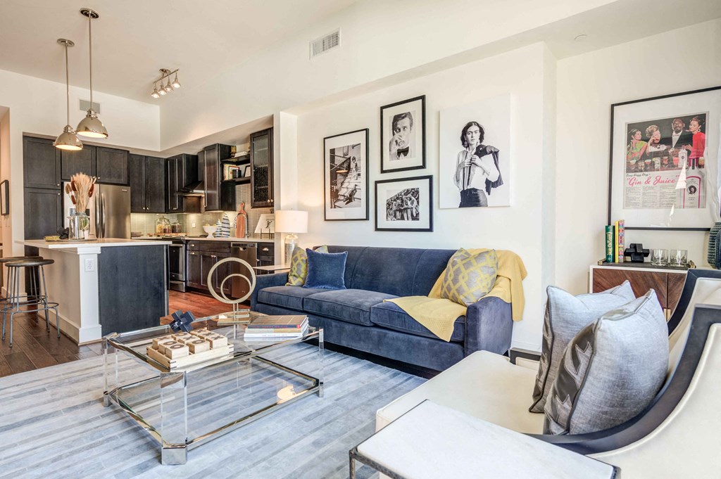 a living room with a blue couch and a table